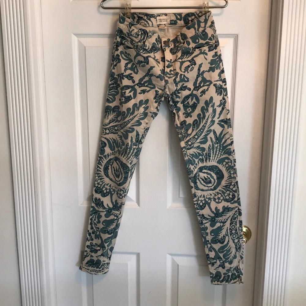 Tan Jeans with retro ink pattern. Zipper ankles